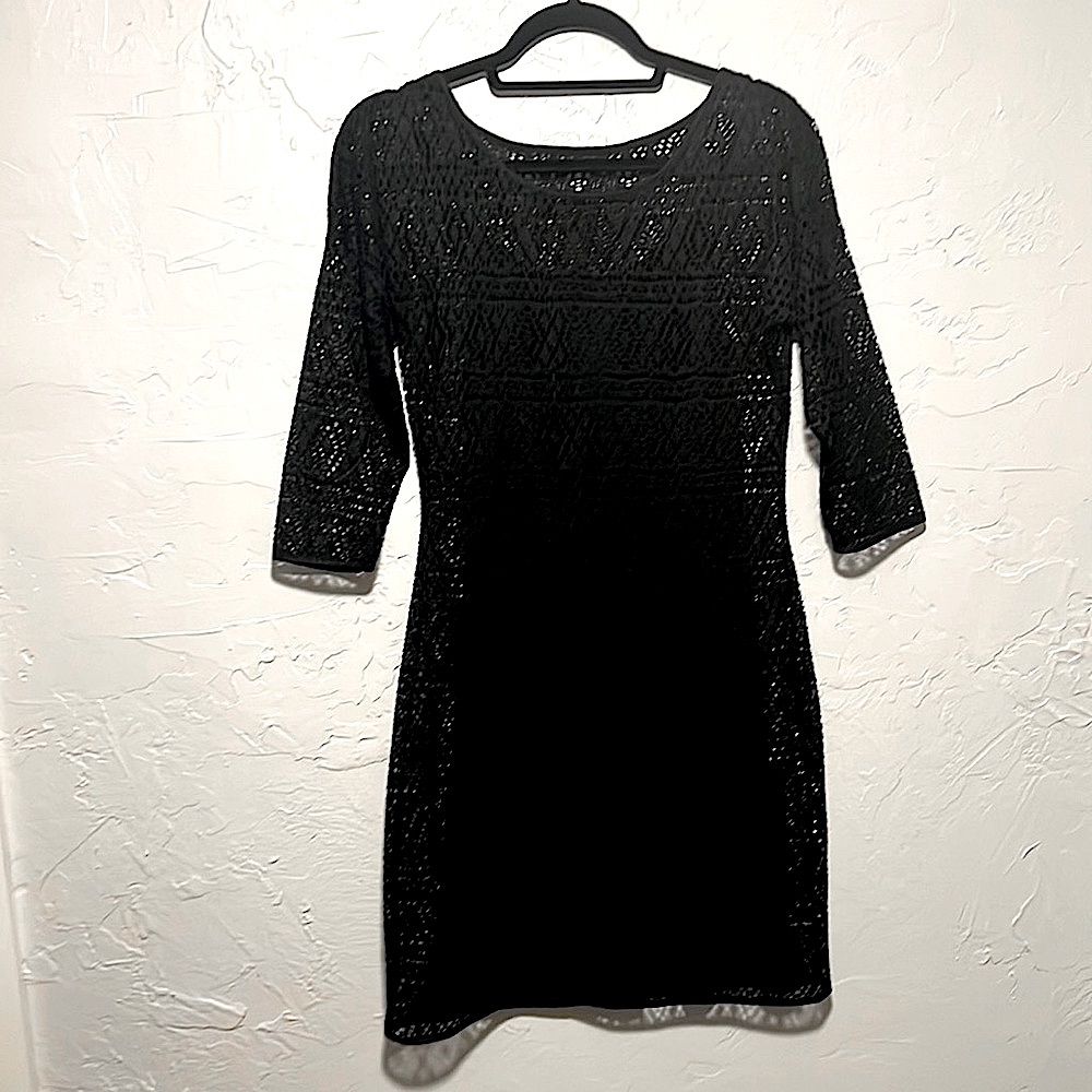 Express black 3/4 length sleeve cocktail dress with see through detail.
